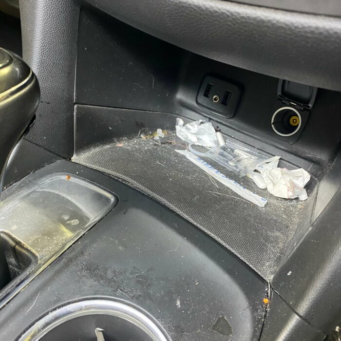 dirty center console with trash