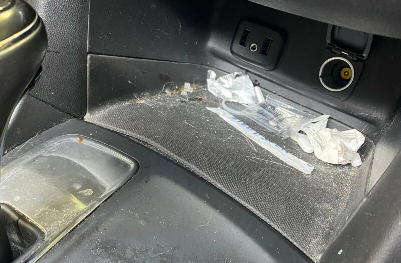 dirty center console with trash