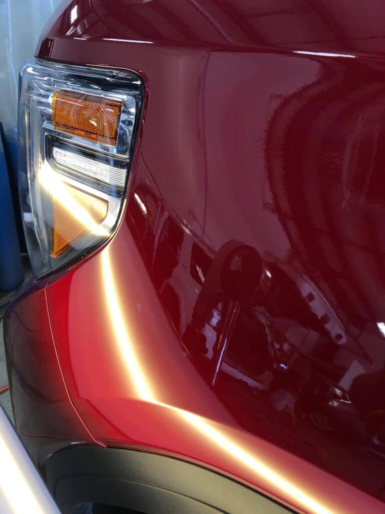 after picture of paintless dent repair on a red SUV