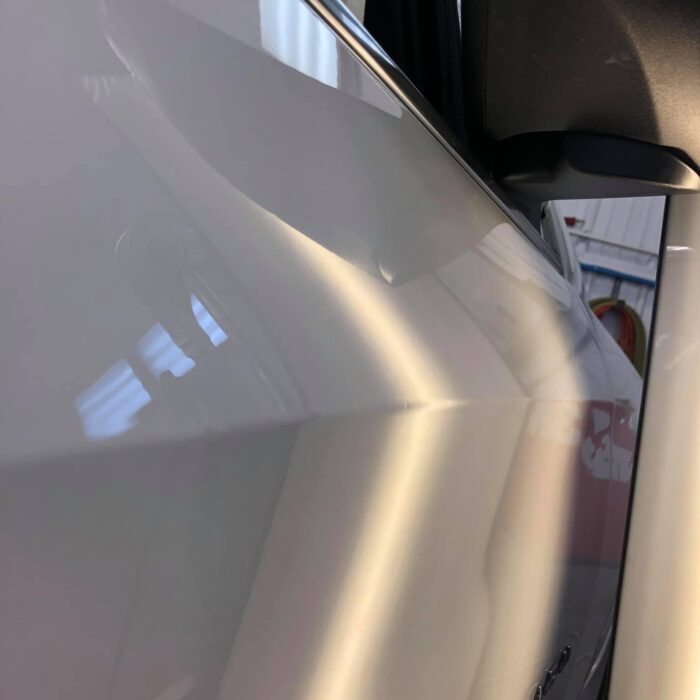 after picture of paintless dent repair on a white SUV