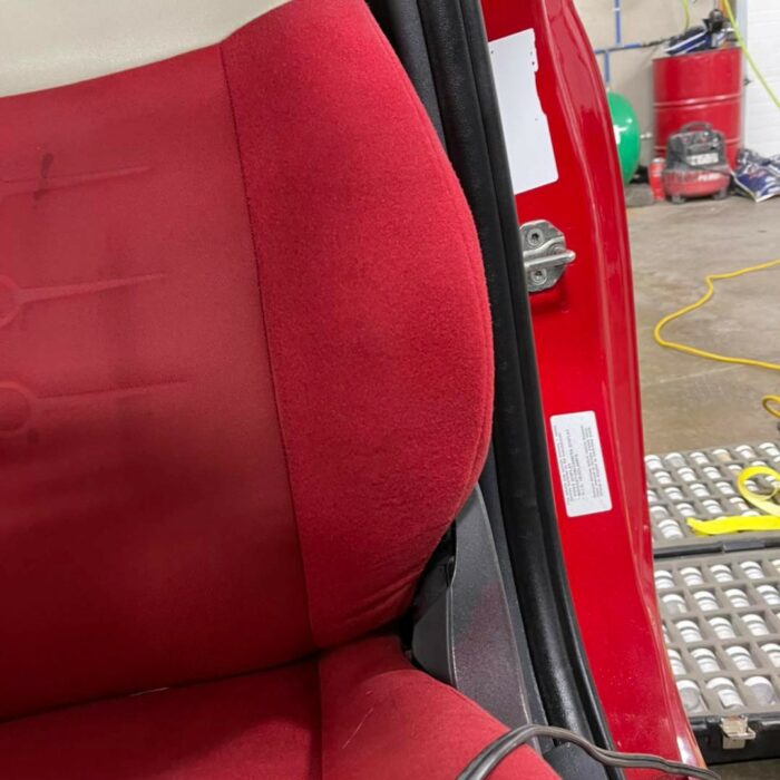 ripped red upholstery after being repaired